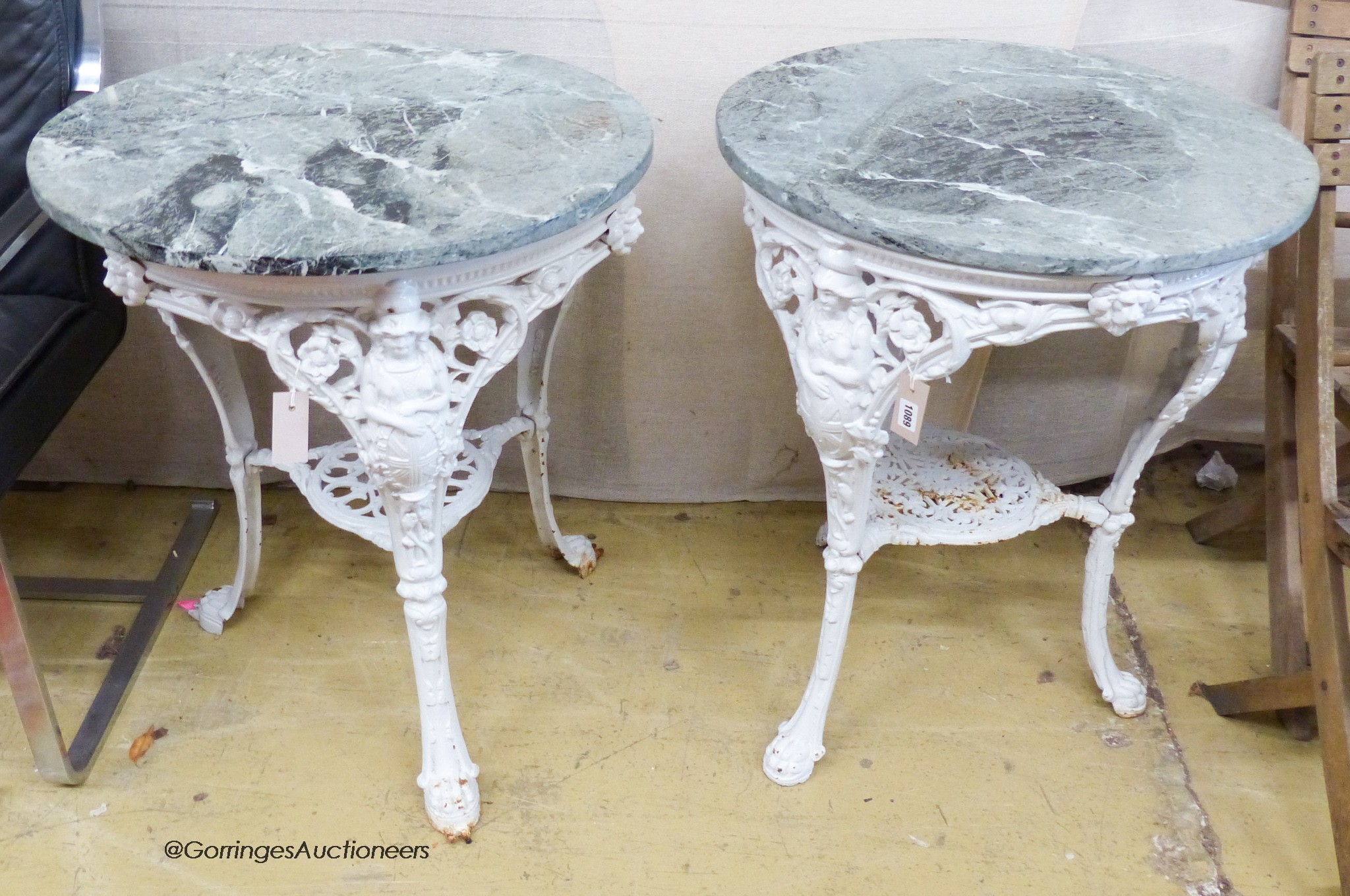 A near pair of Victorian painted cast iron Britannia tables, with later circular marble tops. D-64, H-76cm.